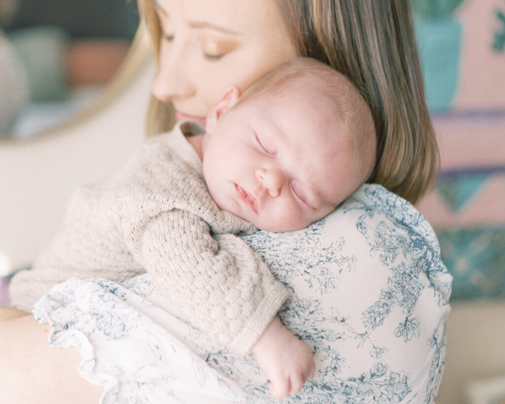Mother snuggling her sleeping newborn by Oklahoma Newborn Photographer COURTNEY CRONIN